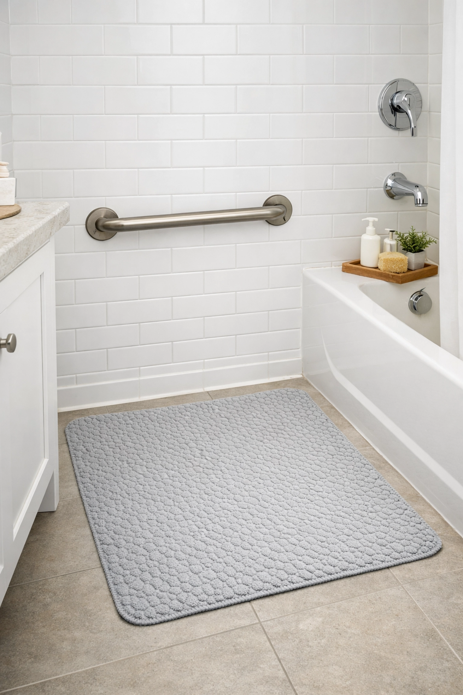 A wall-mounted bathroom grab bar and non-slip floor mat for increased stability and safety.