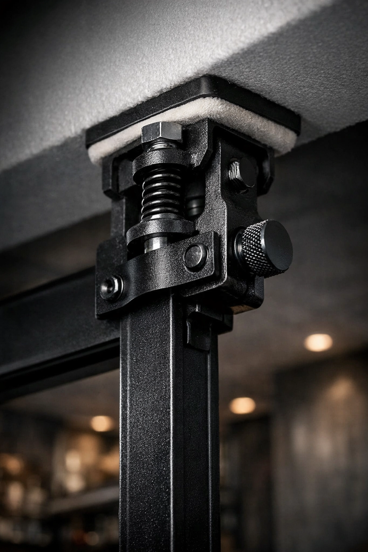 Close-up of a floor to ceiling gym tension mount providing a stable, no-damage anchor point.